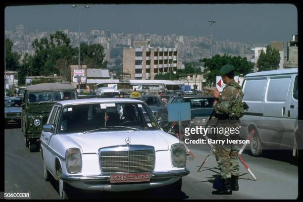 Lebanese Army soldiers stopping cars at checkpoint on main road to Damascus & Bekaa valley at Baabda, overlooking Beirut, Lebanon.