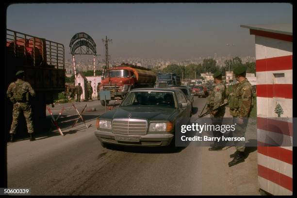 Lebanese Army soldiers stopping cars at checkpoint on main road to Damascus & Bekaa valley at Baabda, overlooking Beirut, Lebanon.