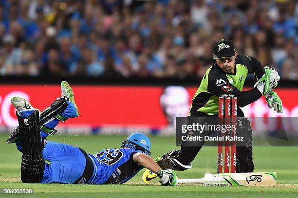 Chris Hartley of the Sydney Thunder attempts a stumping on Alex Ross of the Adelaide Strikers during the Big Bash League Semi Final match between the...