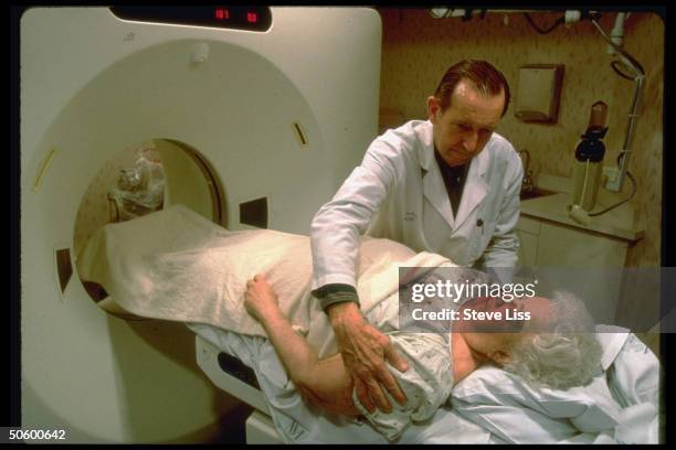 Technician positioning elderly Medicare patient, Isabel Davis, undergoing abdominal CAT scan at Northwestern Memorial Hospital.