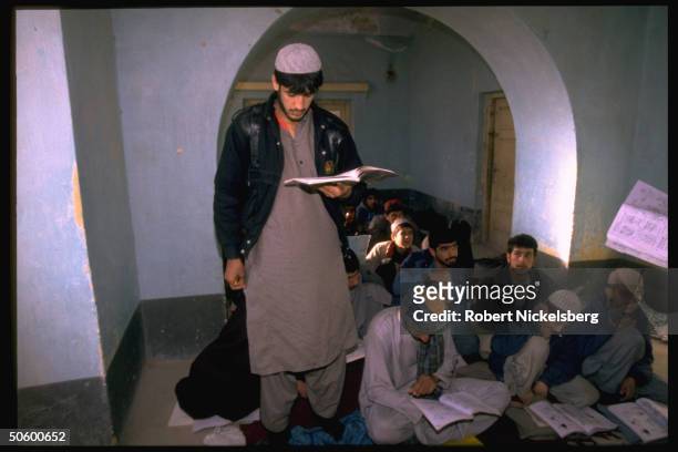 Students, all-male, boys & men, in English language class at self-supporting facility founded by local teachers.