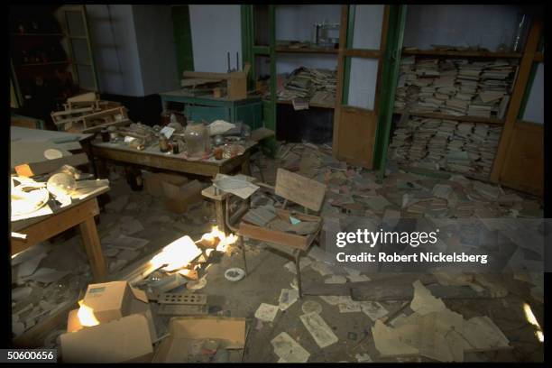 Trashed school-type chemistry lab , torn bks. Strewn on floor, in city under Taliban control, radical Islamic-cleric led faction threatening secular...