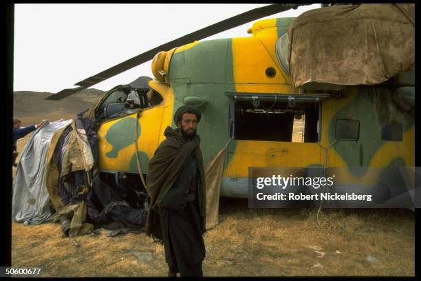 Taliban fighter w. Russian Hind Mi-24 gunship captured by new, Islamic civil war faction in taking opposition mujahedin Hekmatyar's HQ outside Kabul.