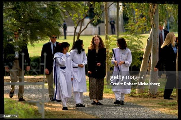 Chelsea Clinton strolling w. Students on campus, visiting college for girls, on Asian tour w. Her US 1st Lady mom.