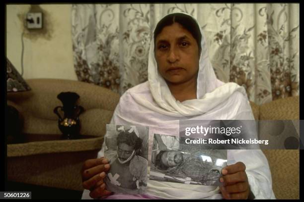 Mother w. Pics of her sons as victims of drive-by shooting, 1 killed, 1 losing leg in 1 of daily incidents of sectarian violence in lawless Karachi,...