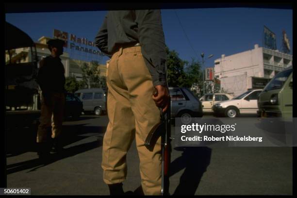 Armed members of special elite police on street patrol, force mil-trained to replace army troops occupying internecine violence-torn city for 30 mos.