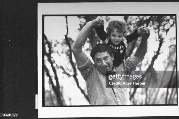 Holocaust survivor Zev Kedem w. Tattooed arm, hoisting son Adam upon his shoulders as they stand outside; he was at Oskar Schindler's factory for a...