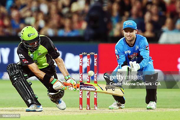 Mike Hussey of the Sydney Thunder plays a shot to get out as Tim Ludeman of the Adelaide Strikers looks on during the Big Bash League Semi Final...