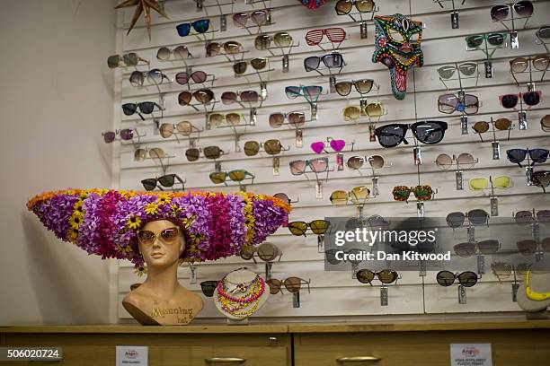 Sun glasses are hung near a wig of flowers displayed in the stockroom at Angels Costume House on January 20, 2016 in London, England. Angels Costumes...