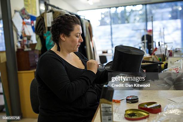 Worker in the alterations department paints a hat at Angels Costumiers on January 20, 2016 in London, England. Angels Costumes established in 1840 is...