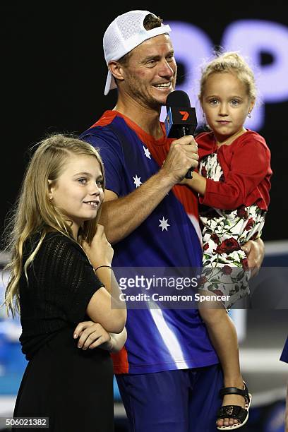 Lleyton Hewitt of Australia is interviewed on court with his children after losing his second round match against David Ferrer of Spain during day...