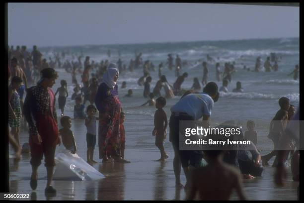 Gazans cooling off in water, enjoying day at beach in Palestinian autonomous Gaza.