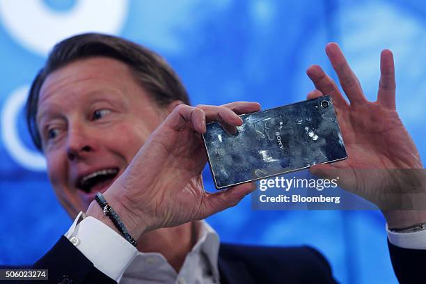 Hans Vestberg, chief executive officer of Ericsson AB, takes a photo on an Sony Corp. Xperia smartphone device during a panel session at the World...
