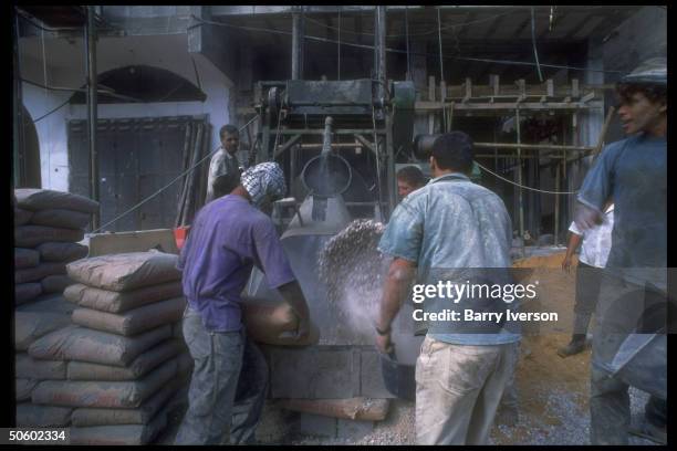 Workers mixing cement on site of highrise bldg. Under construction on Omar Mukhtar Street; Gaza City, Palestinian autonomous Gaza.