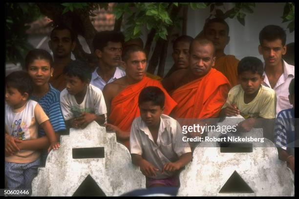 Buddhist monks & laymen during funeral procession & cremation of prop plane pilot shot down by LTTE guerrillas during govt. Mil. Bombing mission.