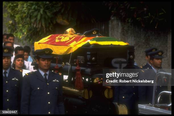 Colleagues bearing coffin of pilot shot down by LTTE rebels during govt. Mil. Bombing mission, in Buddhist cremation funeral procession.