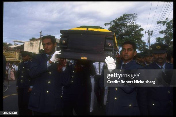 Colleagues bearing coffin of pilot shot down by LTTE rebels during govt. Mil. Bombing mission, in Buddhist cremation funeral procession.