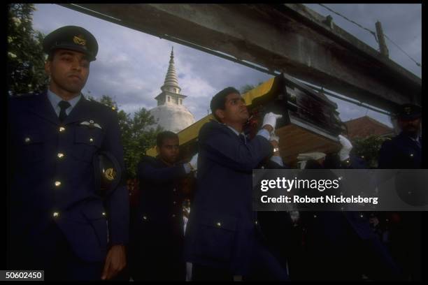 Colleagues bearing coffin of pilot shot down by LTTE rebels during govt. Mil. Bombing mission, in Buddhist cremation funeral procession.