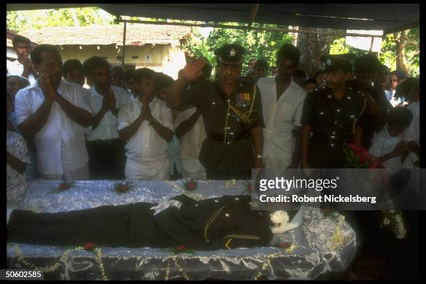 Mourners in Buddhist rite at mil. Funeral for Lance Corporal Alvis, killed by LTTE rebels in Jaffna OP Leap Forward govt. Offensive on Tamil Tigers.