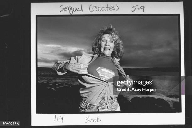 Actress Phyllis Coates, who played Lois Lane in The Adventures of Superman TV series, holding open blouse to reveal Superman insignia on t-shirt...