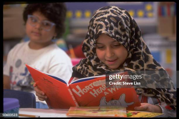 September 1995 - DEARBORN, MI: Arab-American girl reading Dr. Seuss children's classic 'Horton Hear A Who!' in bilingual second grade class at Iris...