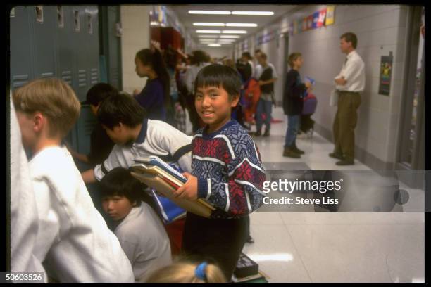 Hmong boy speaking language native to Indochina by locker at Horace Mann Middle School, re bilingual education controversy.