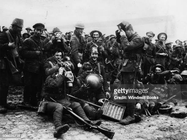 Actions of St. Eloi Craters. Northumberland Fusiliers wearing German helmets and gas masks captured at St. Eloi, 27th March, 1916. 3rd Division....