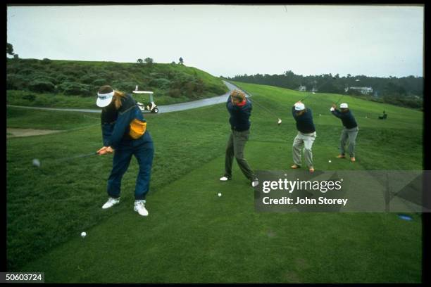 Members of rock band Hootie & the Blowfish, Jim Sonefeld, Mark Bryan, Dean Felber & Darius Rucker on driving range at Pebble Beach Golf Club.