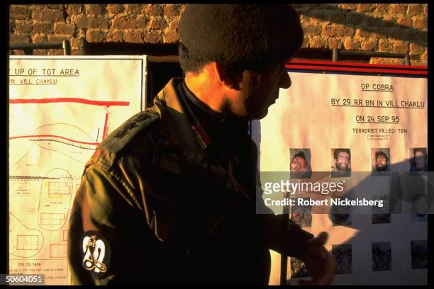 Indian Army officer at chart picturing Kashmiri militants slain in separatist conflict battle w. Indian govt. Troops; Baramulla district of Kashmir...