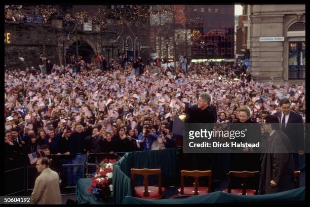 Pres. Bill & Hillary Rodham Clinton framed by US flag-waving crowd gathered to hear him speak; Londonderry.