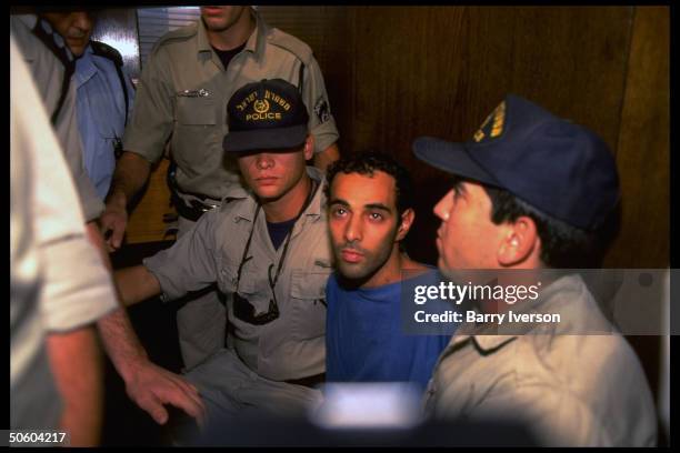 Police-flanked assassin Yigal Amir in court, being arraigned for murder of PM Yitzhak Rabin.