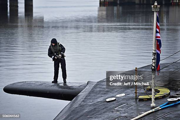 Royal Navy security personnel stand guard on HMS Vigilant at Her Majesty's Naval Base, Clyde on January 20, 2016 in Rhu, Scotland. HMS Vigilant is...