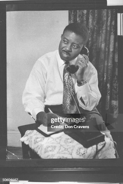 Rev. Ralph Abernathy, co-organizer of segregated bus boycott, talking on telephone, during time of protest over the policy of forcing African...