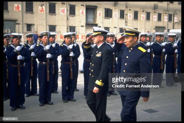 Rear Adm. Walter Doran & his Chinese counterpart Shao Dewan reviewing PLA Navy troops in dockside welcome to port call-paying USS Fort McHenry.