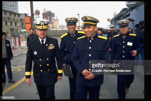 Rear Adm. Walter Doran & his Chinese counterpart Shao Dewan in PLA dockside welcome to port call-paying USS Fort McHenry.