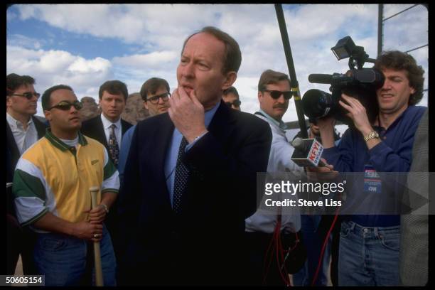 Presidential hopeful Lamar Alexander striking perplexed stance, press et al in-tow, on campaign visit to Oakland A's spring training site.