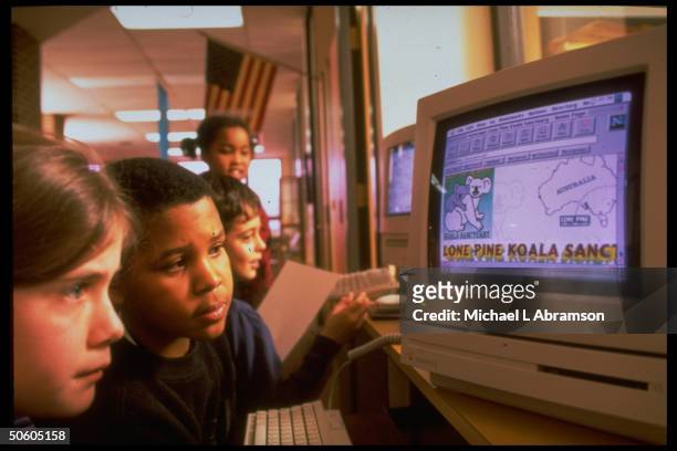 Students at computer, traveling to Australia on Internet, at Horace Mann Elementary School, 1 among half of public schools w. Access to Internet.