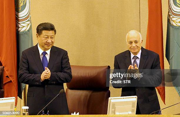 Chinese President Xi Jinping stands next to Arab League chief Nabil al-Arabi as he arrives at the Arab League headquarters on January 21 in the...