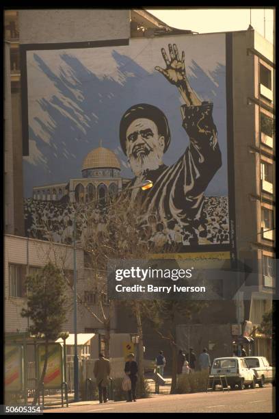 Street scene dominated by large billboard showing the late Iranian leader, Ayatollah Khomeini.