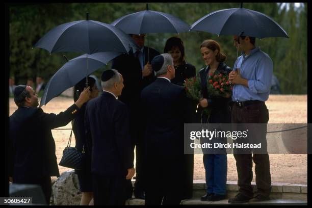 Pres. Clinton w. Rabin's widow Leah & PM Peres , greeting Rabin family at grave of slain PM, visiting re terror & peace.