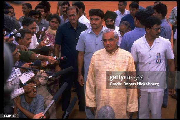 Vajpayee framed by supporters & press after submitting his resignation 13 days into post-election BJP opposition rule.