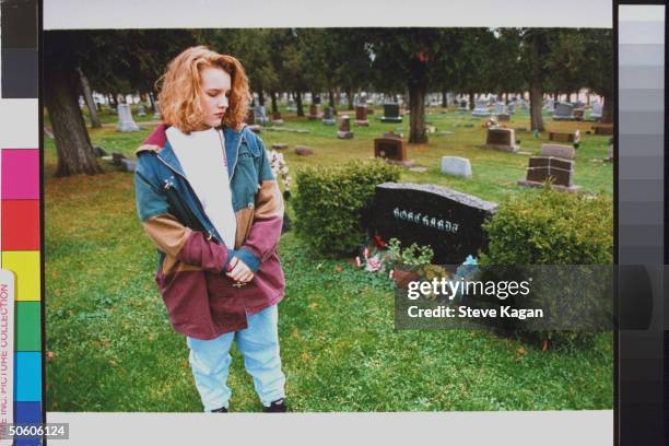 Brook Borchardt standing nr. Grave of father Ruben, who was murdered by 3 teens hired by her stepmother Diane, at cemetery.