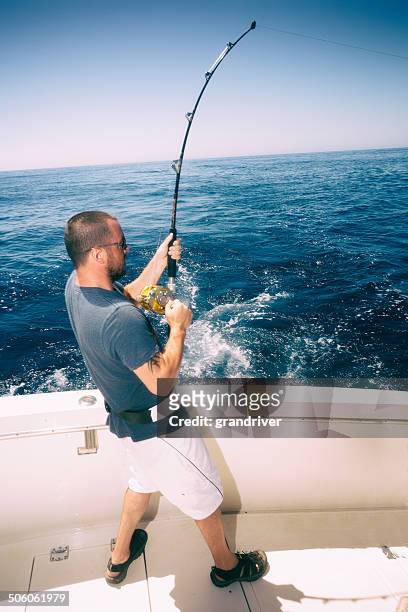deep sea fisherman - young men fishing stock pictures, royalty-free photos & images