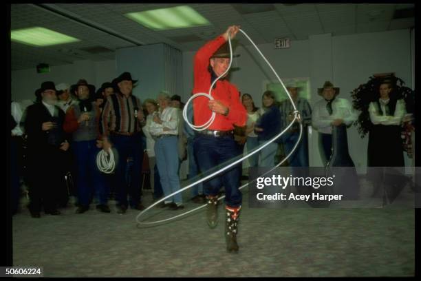 Unident. Cowboy dancing inside circle made by lassoo he's twirling at Twelfth Cowboy Poetry Gathering.