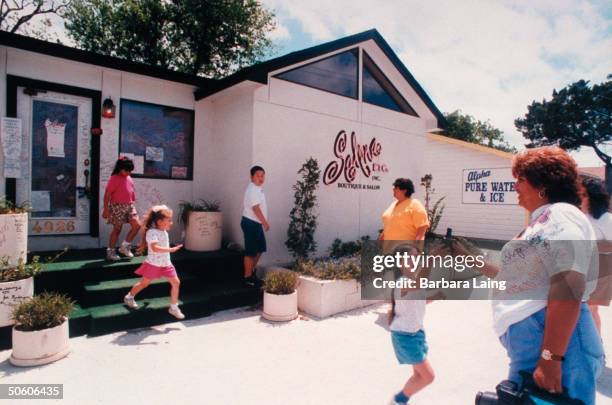 Unident. People standing outside Selena Etc., a boutique & salon owned by slain tejano singer Selena.