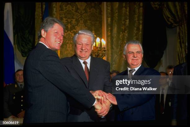Presidents Clinton , Yeltsin & Kravchuk of Ukraine sealing signing of nuclear disarmament agreement w. 3-way handshake, at Kremlin.