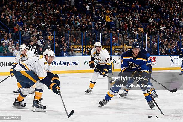 Carl Gunnarsson of the St. Louis Blues handles the puck as Shea Weber of the Nashville Predators defends on December 29, 2015 at Scottrade Center in...