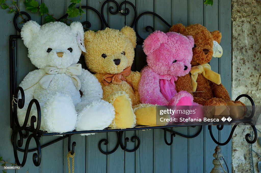 Four teddy bear on a bench