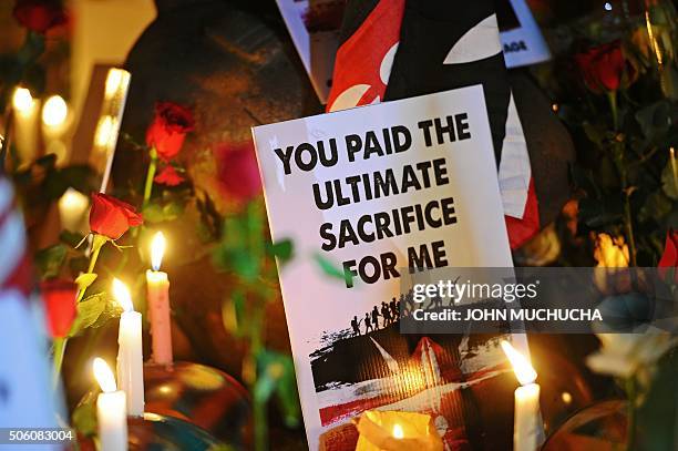 Sign is pictured during a candle lit vigil in honour of Kenya Defence Force soldiers on January 21, 2016 in Nairobi. Large numbers of KDF soldiers...