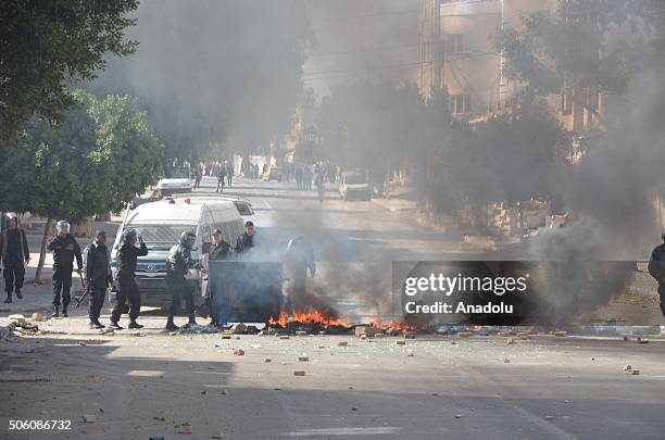 Burning tires are seen at a blocked road during a protest, staged by unemployed young citizens against unemployment and poverty in Tataouine, Tunisia...